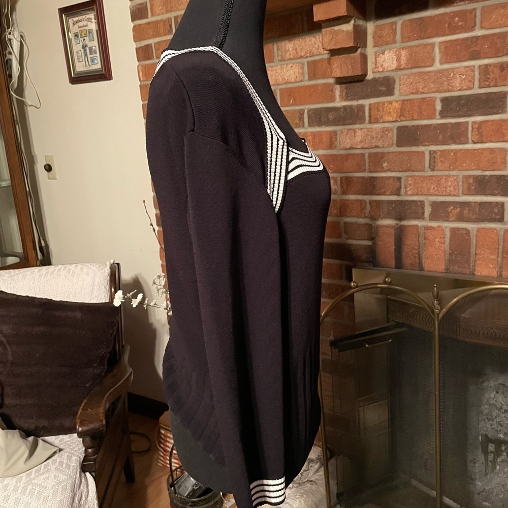 New York City Design Co. black sweater with striped trim on chest and sleeve.